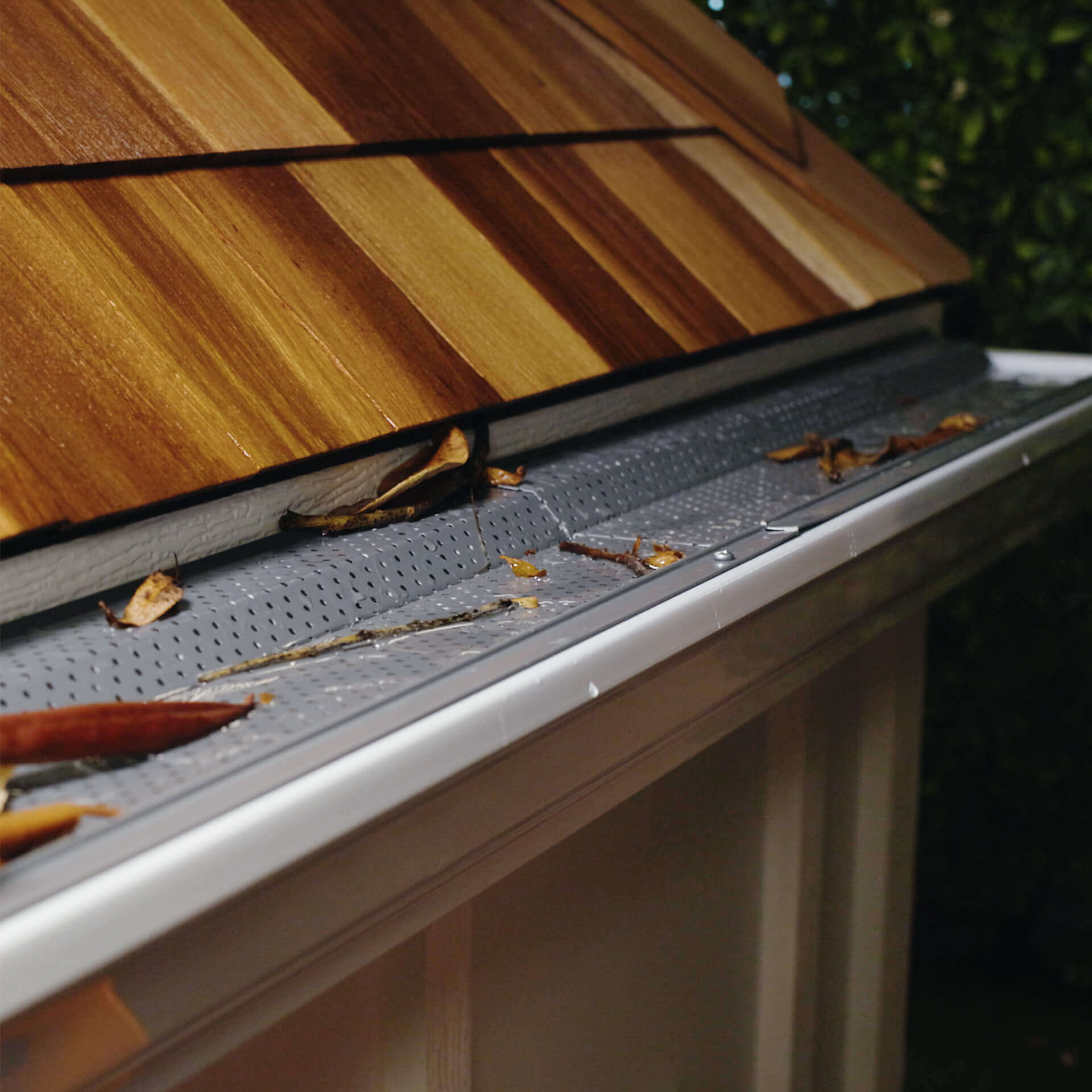 In-use, close-up image of the gutter guard installed on roof.